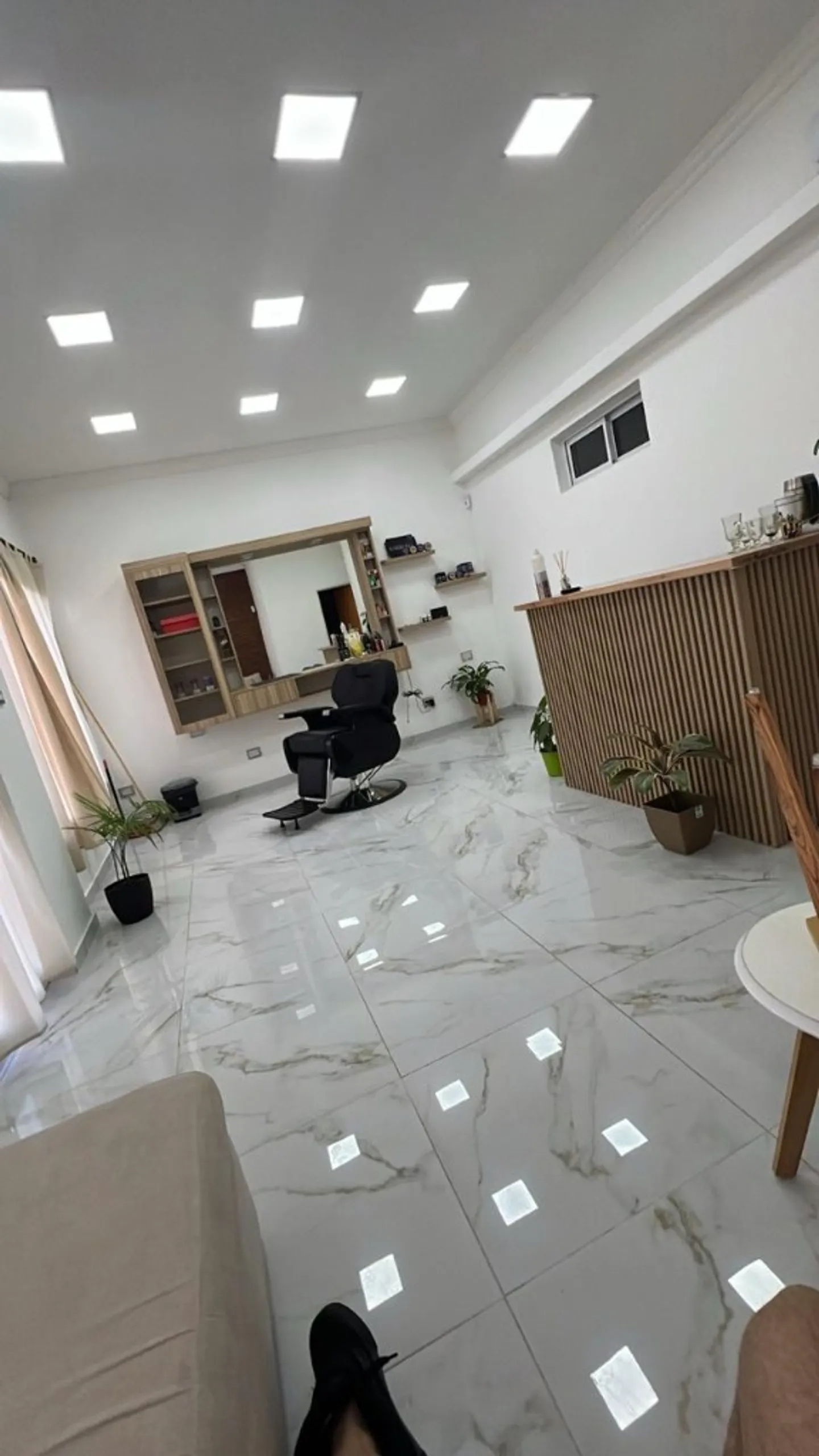 Vista amplia del salón Visage: ambiente luminoso, suelo de mármol y mobiliario minimalista.
